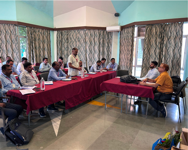 Manish Balyan and Subodh Kumar sitting at a table in front of the global agro team.