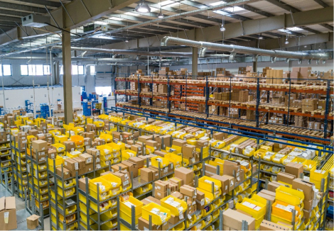 Overview of a large warehouse packed with cartons of goods.